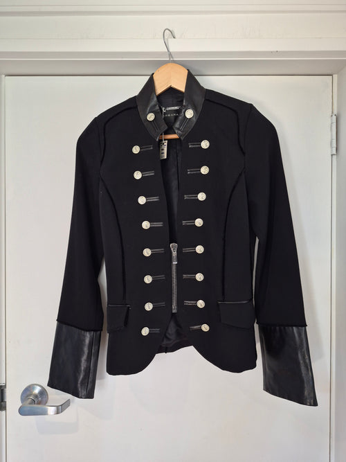 Black leather jacket with white studs on a white background